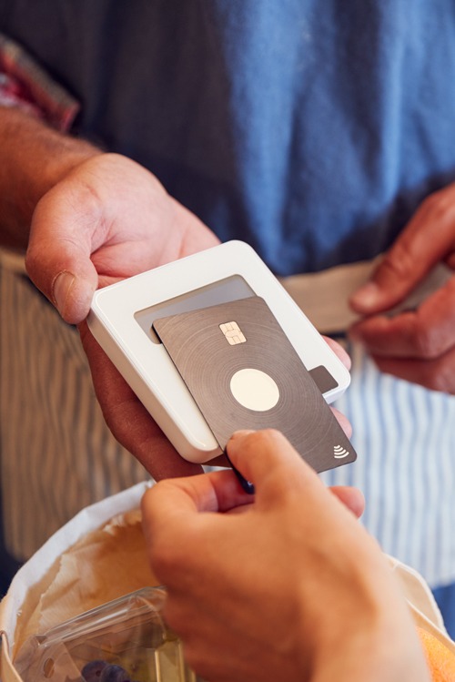 ropped view of african american waiter working with credit card